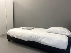 a white bed with a laptop on top of it at ღ Calysta - Studio Proche Centre Ville & Gare in Douai