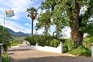 a flag flying in front of a white fence at Val Du Charron Wine & Leisure Estate in Wellington +148 photos