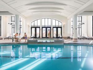 a pool in a building with people walking around it at Fairmont Le Chateau Frontenac in Quebec City