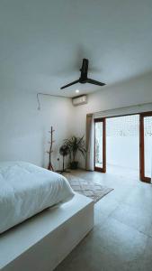 a bedroom with a bed and a ceiling fan at Chic 2BR Villa w/Rock Plunge Pool in Denpasar