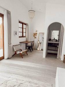 a living room with a table and a mirror at Chic 2BR Villa w/Rock Plunge Pool in Denpasar