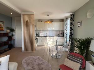 a kitchen with a table and chairs in a room at Golden hours luxury and panoramic view in Nice