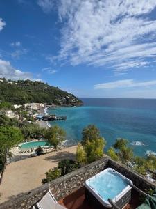 a view of the ocean from the balcony of a house at Camping Villaggio Nettuno in Nerano