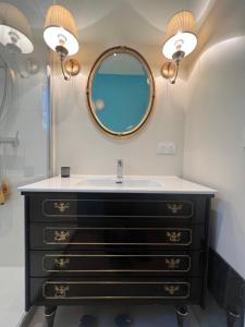 a bathroom with a sink and a mirror at Golden hours luxury and panoramic view in Nice