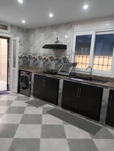 a kitchen with a stove and a counter top at Maison de repo in Mostaganem