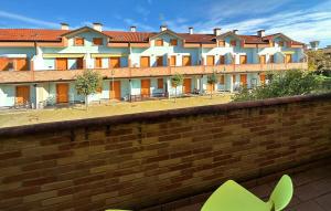 a building with a brick wall in front of it at Solmare 5116 in Rosapineta