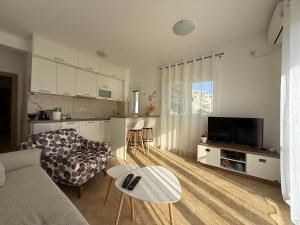 a living room with a couch and a table at BlueCoast Apartment in Herceg-Novi