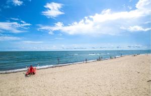 a person sitting in a chair on the beach at Solmare 5116 in Rosapineta +23 photos