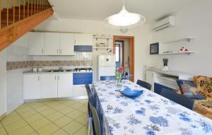 a kitchen with a table with a vase of flowers on it at Solmare 5116 in Rosapineta