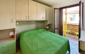 a bedroom with a green bed and a window at Solmare 5116 in Rosapineta