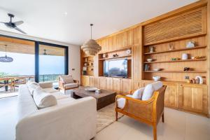 a living room with a couch and chairs and a table at Casa Daria Sofia - Ocean Views Infinity Pool Escape with Cinema & Gym in Uluwatu +53 photos
