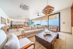 a living room with a couch and a table at Casa Daria Sofia - Ocean Views Infinity Pool Escape with Cinema & Gym in Uluwatu
