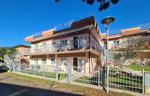 a building with a fence in front of it at Milla 2 in Rosolina Mare +10 photos
