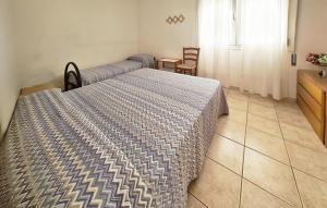 a bedroom with two beds and a table and chairs at Milla 2 in Rosolina Mare