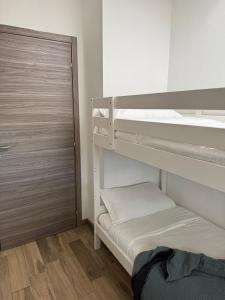 a room with two bunk beds and a door at Residence Principe di Saronno in Saronno