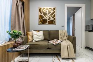a living room with a couch and a table at Ugo Bassi Apartments in Bologna