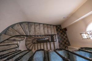 a spiral staircase in a building with a window at La Vite 94 in Rome