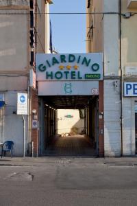 a building with a sign for a hotel at Parking Hotel Giardino in Livorno