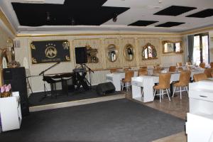 a room with a stage and a table and chairs at ANGRAND HOTEL in Ankara