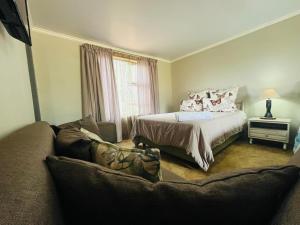 a living room with a bed and a couch at Lavender Lane in Denysville