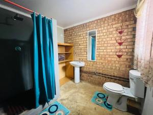 a bathroom with a toilet and a sink at Lavender Lane in Denysville +14 photos