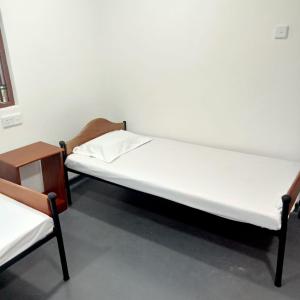 a bed and two chairs in a room at Cenesco Rest in Induruwa