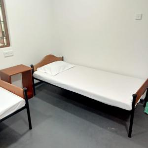 a bed and two chairs in a room at Cenesco Rest in Induruwa