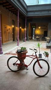 a red bike parked in front of a building at A la Gurda Hostel - Barrio Sur in San Miguel de Tucumán