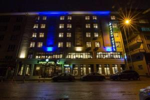 a large building with blue lights on it at night at ANGRAND HOTEL in Ankara