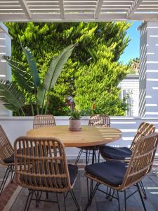a wooden table and chairs on a patio at Corina Studios-Apartments in Naousa