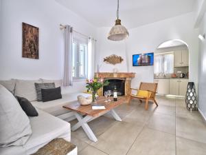 a living room with a couch and a table at Corina Studios-Apartments in Naousa