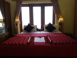 a large bed in a room with a large window at Beach Florra Inn in Kovalam