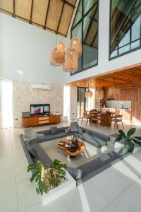 a living room with a couch and a table at Pai Prestige - Luxury Pool Villas in the centre of Pai in Pai +36 photos