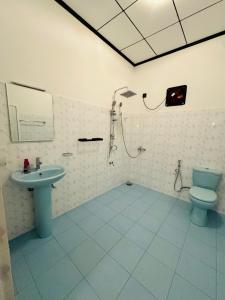 Un baño con ducha, inodoro y lavabo. en Hotel Elysian, en Udawalawe