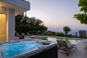 a jacuzzi tub on a patio with a view at Vista by Del Sol Villa in Rhodes Town