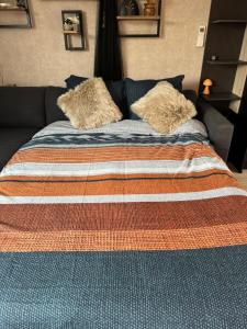 a bed with two pillows on top of it at B&B Wellness Garden in Herzele +39 photos