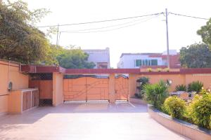 an outdoor area of a house with a fence at Majestic BnB in Karachi