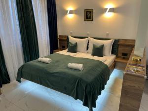 La Luna Premium Deluxe Apartment with Pool & Jacuzzi, Bikes and Covered Parking في Našice: غرفة نوم بسرير كبير عليها وسادتين