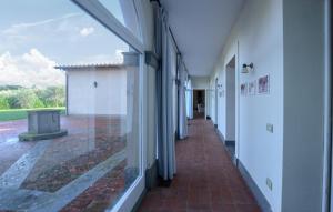 an empty hallway of a building with a view of a courtyard at Beautiful Home In Ansedonia in Ansedónia +36 photos