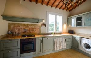 a kitchen with a stove top oven next to a window at Beautiful Home In Ansedonia in Ansedónia