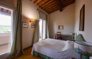 a bedroom with a bed and a large window at Beautiful Home In Ansedonia in Ansedónia