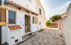 an alleyway leading to a white building with a door at Stunning Home In Carloforte With Wifi in Carloforte