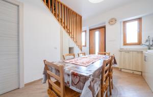 a kitchen and dining room with a table and chairs at Stunning Home In Carloforte With Wifi in Carloforte