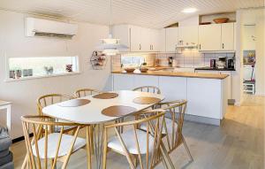 a kitchen with a table and chairs in a kitchen at Gorgeous Home In Assens With Wifi in Assens