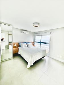 Ένα ή περισσότερα κρεβάτια σε δωμάτιο στο Cobertura frente mar - Nova, primeiro Aluguel!