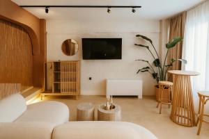 a living room with a couch and a tv at Marabou Unique Stay in Thessaloniki