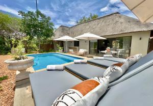 an image of a swimming pool in front of a house at Wildlife Estate Villa - Pool - Boma - Bushlife in Hoedspruit