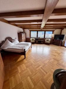 a large bedroom with a bed and a living room at Bed & Breakfast Schäfer in Enzklösterle +45 photos