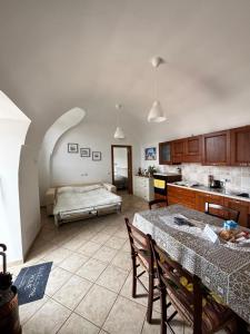 a kitchen with a table and a bed in a room at A Casa di Ilary in Ravello +8 photos