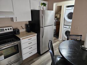 a kitchen with a stainless steel refrigerator and a table at Marine B Two Bedrooms One-Half Bathrooms Townhouse in Everett